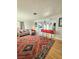 Open-concept living area featuring a breakfast bar connecting to the kitchen and hardwood floors with large decorative rug at 424 N 16Th St, Las Vegas, NV 89101
