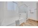 Modern bathroom with bathtub, glass-enclosed shower, and a large window at 7908 Morning Gallop Ct, Las Vegas, NV 89131