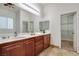 Bathroom featuring double sink vanity and walk in closet at 7908 Morning Gallop Ct, Las Vegas, NV 89131