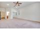Large carpeted bedroom with ceiling fan, ensuite access, and ample closet space at 7908 Morning Gallop Ct, Las Vegas, NV 89131