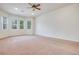 Spacious carpeted bedroom featuring multiple windows that provide an abundance of natural light at 7908 Morning Gallop Ct, Las Vegas, NV 89131