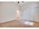 Large carpeted bedroom featuring ceiling fan and access to the ensuite at 7908 Morning Gallop Ct, Las Vegas, NV 89131