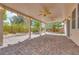 This covered patio features a brick-paved floor, a ceiling fan, and provides an inviting outdoor living space at 7908 Morning Gallop Ct, Las Vegas, NV 89131