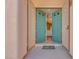 Inviting front entrance features stylish, light-blue double doors and a colorful welcome mat at 7908 Morning Gallop Ct, Las Vegas, NV 89131