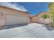 This property boasts a three-car garage with plenty of driveway space on a sunny day at 7908 Morning Gallop Ct, Las Vegas, NV 89131