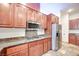 Well-equipped kitchen with granite countertops, stainless steel appliances, and wooden cabinetry at 7908 Morning Gallop Ct, Las Vegas, NV 89131