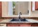 Close-up of a modern kitchen sink with elegant faucet and granite countertop at 7908 Morning Gallop Ct, Las Vegas, NV 89131