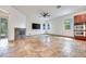 Bright living room with stone fireplace, large windows, and travertine flooring at 7908 Morning Gallop Ct, Las Vegas, NV 89131