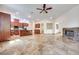 The living room has tile floors, stone fireplace, open floorplan, and lots of light at 7908 Morning Gallop Ct, Las Vegas, NV 89131