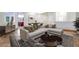 Spacious living area with stylish sectional sofa and view into dining area at 7908 Morning Gallop Ct, Las Vegas, NV 89131