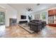 Comfortable living room with stone fireplace, large windows, and built-in double ovens at 7908 Morning Gallop Ct, Las Vegas, NV 89131