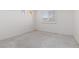 Bedroom with neutral carpet, white walls, and one window with natural light at 8516 Montago Valley Ave, Las Vegas, NV 89117
