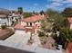 Charming two-story home with a terra cotta roof, private balcony, drought tolerant landscaping, and attached two-car garage at 8516 Montago Valley Ave, Las Vegas, NV 89117