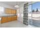 Kitchen with light wood cabinets and sliding glass door to backyard at 8516 Montago Valley Ave, Las Vegas, NV 89117