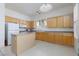 Bright kitchen with light wood cabinets, island, white appliances and shutters at 8516 Montago Valley Ave, Las Vegas, NV 89117