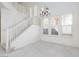 Bright living room with carpet, staircase and plantation shutters on the windows at 8516 Montago Valley Ave, Las Vegas, NV 89117