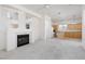 Bright living space with white fireplace, plush carpet and open kitchen area at 8516 Montago Valley Ave, Las Vegas, NV 89117