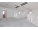 Open living space with neutral carpet and bright white walls, staircase and bathroom nearby at 8516 Montago Valley Ave, Las Vegas, NV 89117