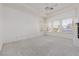 Bright main bedroom featuring carpet, tray ceilings, and white walls and trim at 8516 Montago Valley Ave, Las Vegas, NV 89117