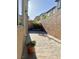 View of narrow backyard space with a paved area and tall block wall at 8920 Appellation Ave, Las Vegas, NV 89148