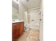 Bathroom featuring a shower over tub and a brown vanity with white countertop at 8920 Appellation Ave, Las Vegas, NV 89148