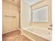 Bright bathroom featuring a shower and tub and a window letting in natural light at 8920 Appellation Ave, Las Vegas, NV 89148