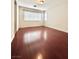 Empty bedroom with wood flooring and natural light from one window at 8920 Appellation Ave, Las Vegas, NV 89148