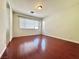 Bright bedroom with hardwood floors and a large window offering ample natural light at 8920 Appellation Ave, Las Vegas, NV 89148