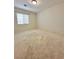Empty carpeted bedroom with one large window providing natural light at 8920 Appellation Ave, Las Vegas, NV 89148