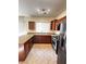 Traditional kitchen equipped with stainless steel appliances, granite counters, and wood cabinets at 8920 Appellation Ave, Las Vegas, NV 89148
