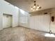 Spacious living room featuring tile flooring, large windows, and a modern light fixture at 8920 Appellation Ave, Las Vegas, NV 89148