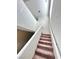 Carpeted staircase with white railing leads to the upper level, offering a seamless transition between floors at 8920 Appellation Ave, Las Vegas, NV 89148