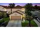Charming two-story home with a well-manicured lawn, attached garage, and inviting curb appeal at 9409 Kayla Ct, Las Vegas, NV 89134