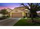 Charming two-story home with a well-manicured lawn, attached garage, and a mature tree at 9409 Kayla Ct, Las Vegas, NV 89134