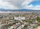 An aerial view of a neighborhood in Nevada featuring mountain views, sunny and cloudy skies at 1501 Via Salaria Ct, Henderson, NV 89052
