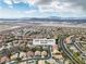 Nevada neighborhood featuring an aerial view with desert and mountain views under a bright, cloudy sky at 1501 Via Salaria Ct, Henderson, NV 89052