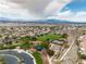 Aerial view of a Nevada neighborhood park with tennis and basketball courts under cloudy skies at 1501 Via Salaria Ct, Henderson, NV 89052