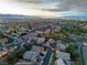 Nevada neighborhood aerial view with warm sunset, city lights, and mountain views in the background at 1501 Via Salaria Ct, Henderson, NV 89052