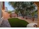 Artificial grass lawn in backyard with mature shade trees at 1501 Via Salaria Ct, Henderson, NV 89052