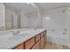 Bathroom featuring double sink vanity, white countertops, and shower with tub at 1501 Via Salaria Ct, Henderson, NV 89052