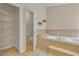 Bathroom featuring a soaking tub, toilet room, and walk-in closet at 1501 Via Salaria Ct, Henderson, NV 89052