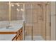 Bathroom featuring a single sink, wood cabinets, and a tiled glass-enclosed shower at 1501 Via Salaria Ct, Henderson, NV 89052