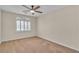 Bedroom featuring ceiling fan, neutral carpet, and shuttered window at 1501 Via Salaria Ct, Henderson, NV 89052