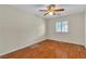Bedroom showcasing shuttered window, ceiling fan and wood-look flooring at 1501 Via Salaria Ct, Henderson, NV 89052