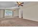 Spacious bedroom with carpet, ceiling fans, and natural light from a large window at 1501 Via Salaria Ct, Henderson, NV 89052