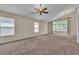 Spacious bedroom with carpet, ceiling fans, and natural light from large windows at 1501 Via Salaria Ct, Henderson, NV 89052