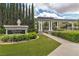 Elegant community entrance with manicured landscaping and decorative pillars under a cloudy sky at 1501 Via Salaria Ct, Henderson, NV 89052