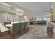 Staged dining room and living room with neutral tones and elegant furnishings at 1501 Via Salaria Ct, Henderson, NV 89052