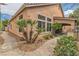 Exterior view of home with landscaped yard, walkway, and covered parking at 1501 Via Salaria Ct, Henderson, NV 89052
