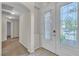 Bright foyer featuring decorative glass front door and tile flooring at 1501 Via Salaria Ct, Henderson, NV 89052